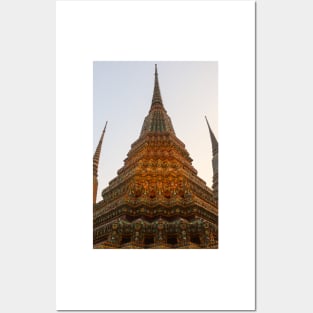 Low angle view of a Buddha stupa reaching symmetrical in the clear sky. Posters and Art